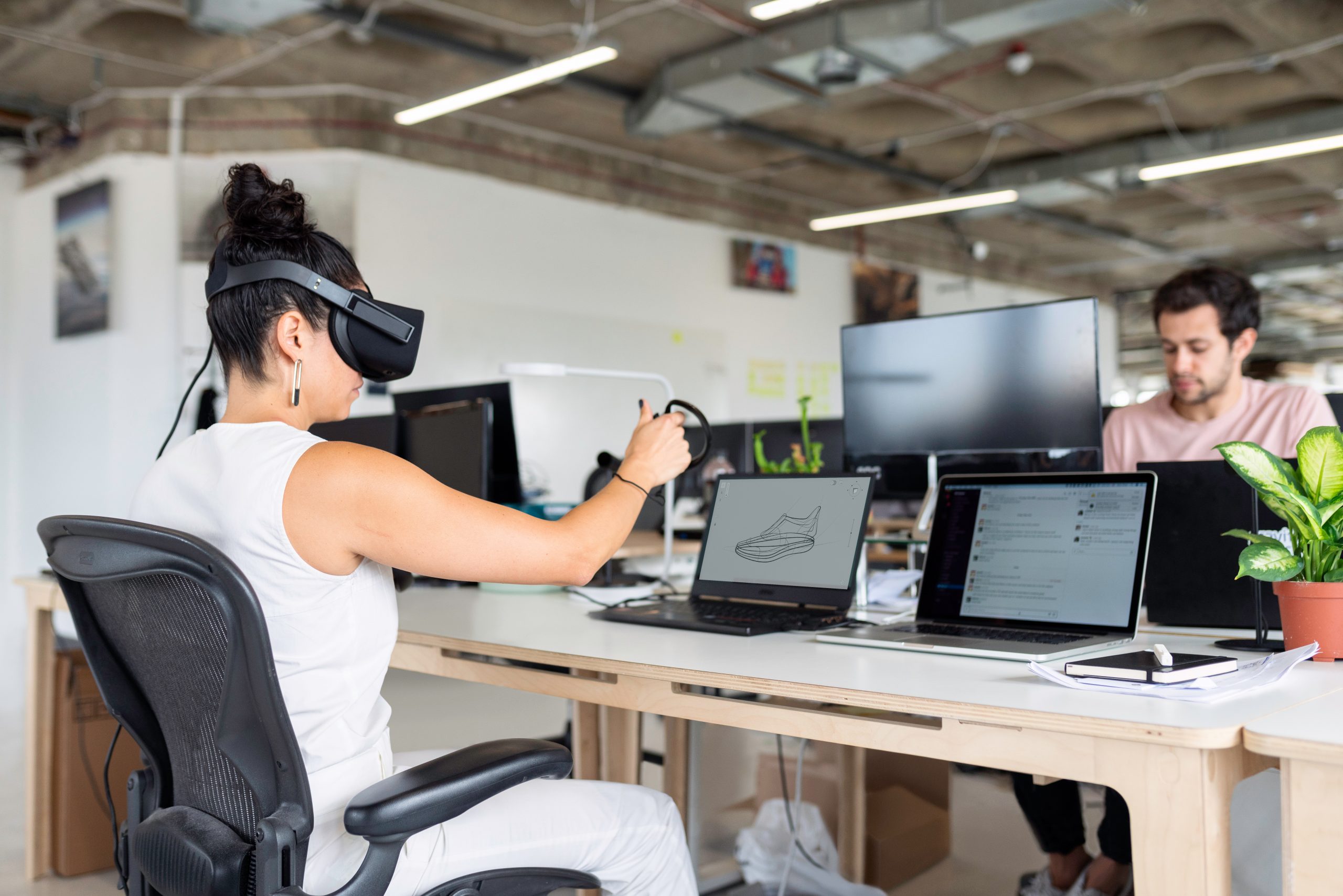 Woman Using Laptop Computer With VR Headset (Virtual Reality