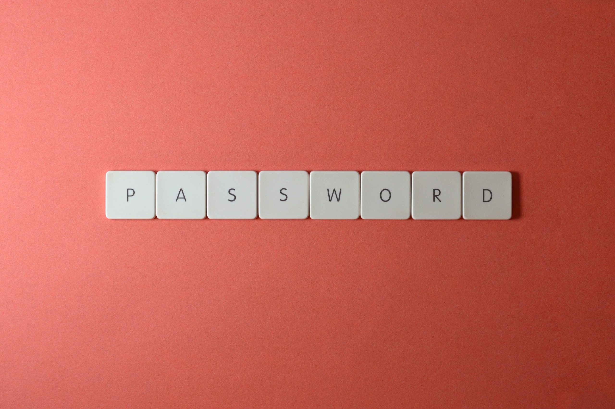 Password in scribble letter on orange red background to symbolise password manager