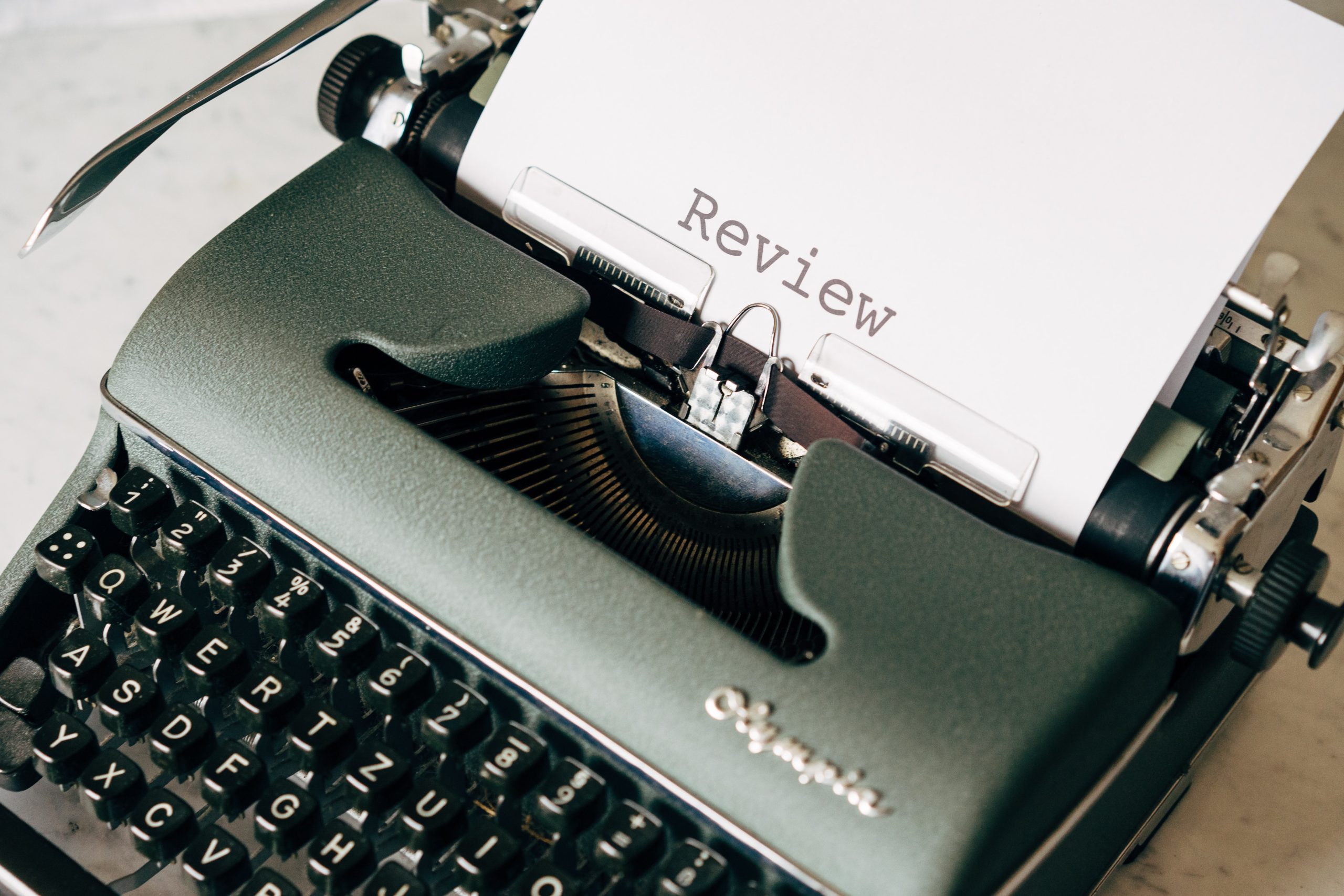 Typewriter with Review written on a piece of Paper