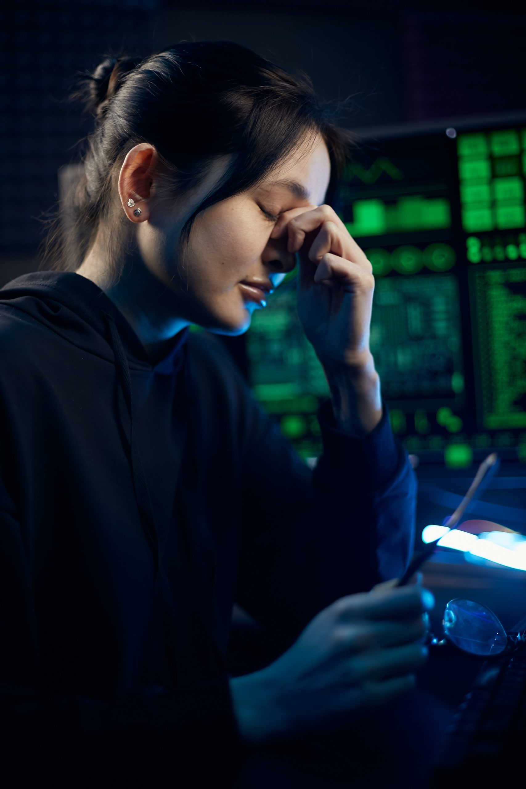 Women in black long sleeve shirt holding smart phone.